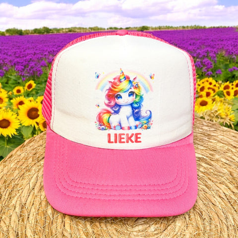 Roze kinderpetje met witte voorkant, bedrukt met een kleurrijke eenhoorn en gepersonaliseerde naam in vrolijke letters.