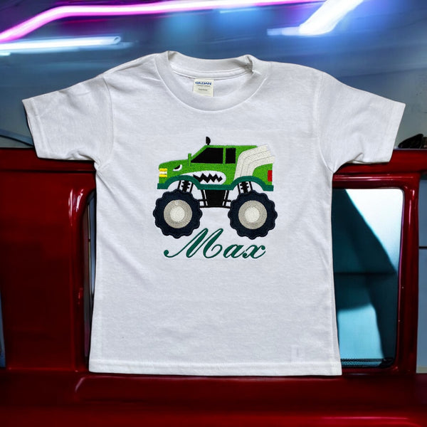 Kindershirt in wit of zwart in de maten 56 tm 164 met korte of lange mouwen. Op het shirt wordt  een groene monster truck geborduurd. Onder de monster truck wordt in het rood de naam van het kind geborduurd.