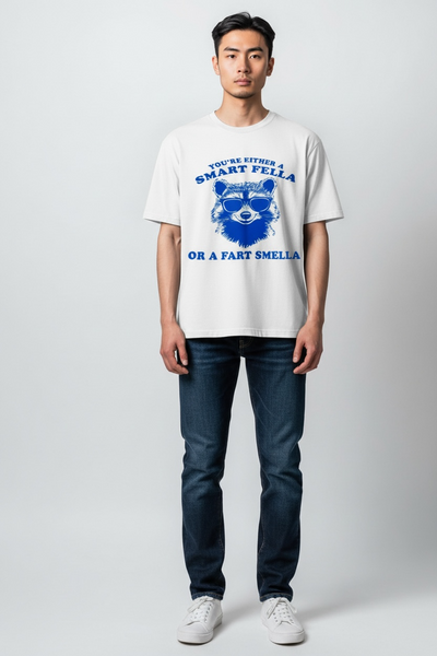 Unisex T-shirt voor volwassenen met blauwe bedrukking van een stoere wasbeer met zonnebril en de tekst "You're Either a Smart Fella or a Fart Smella", humoristisch design van SaZuDesigns.